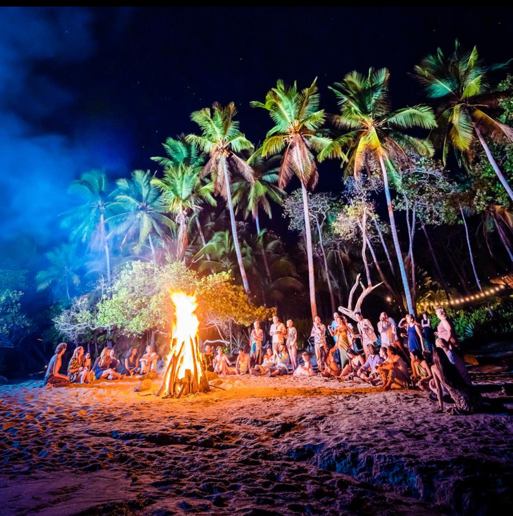 Beach bonfire under palm trees in Costa Rica